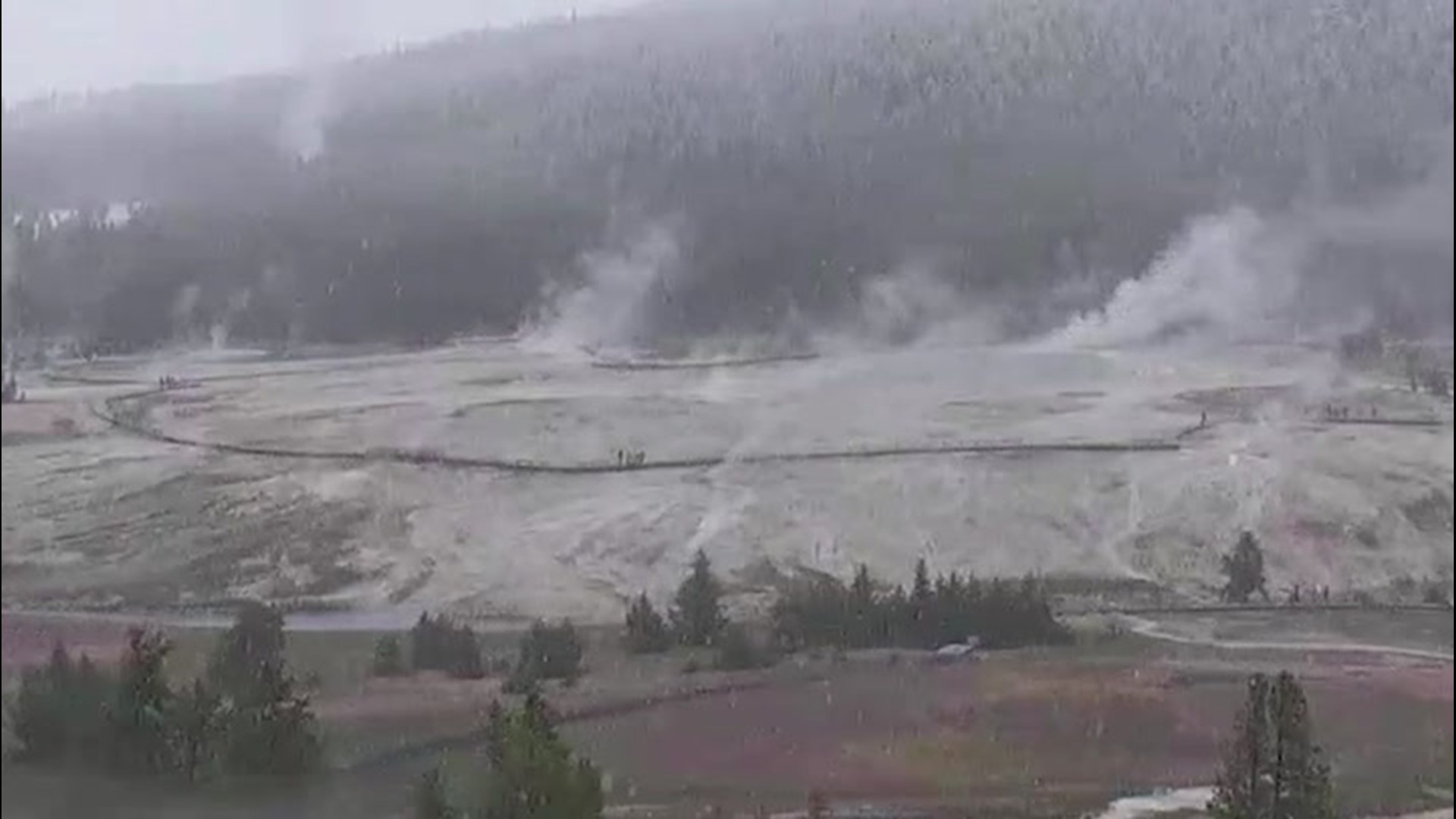 Snow falls over Yellowstone's steamy landscape