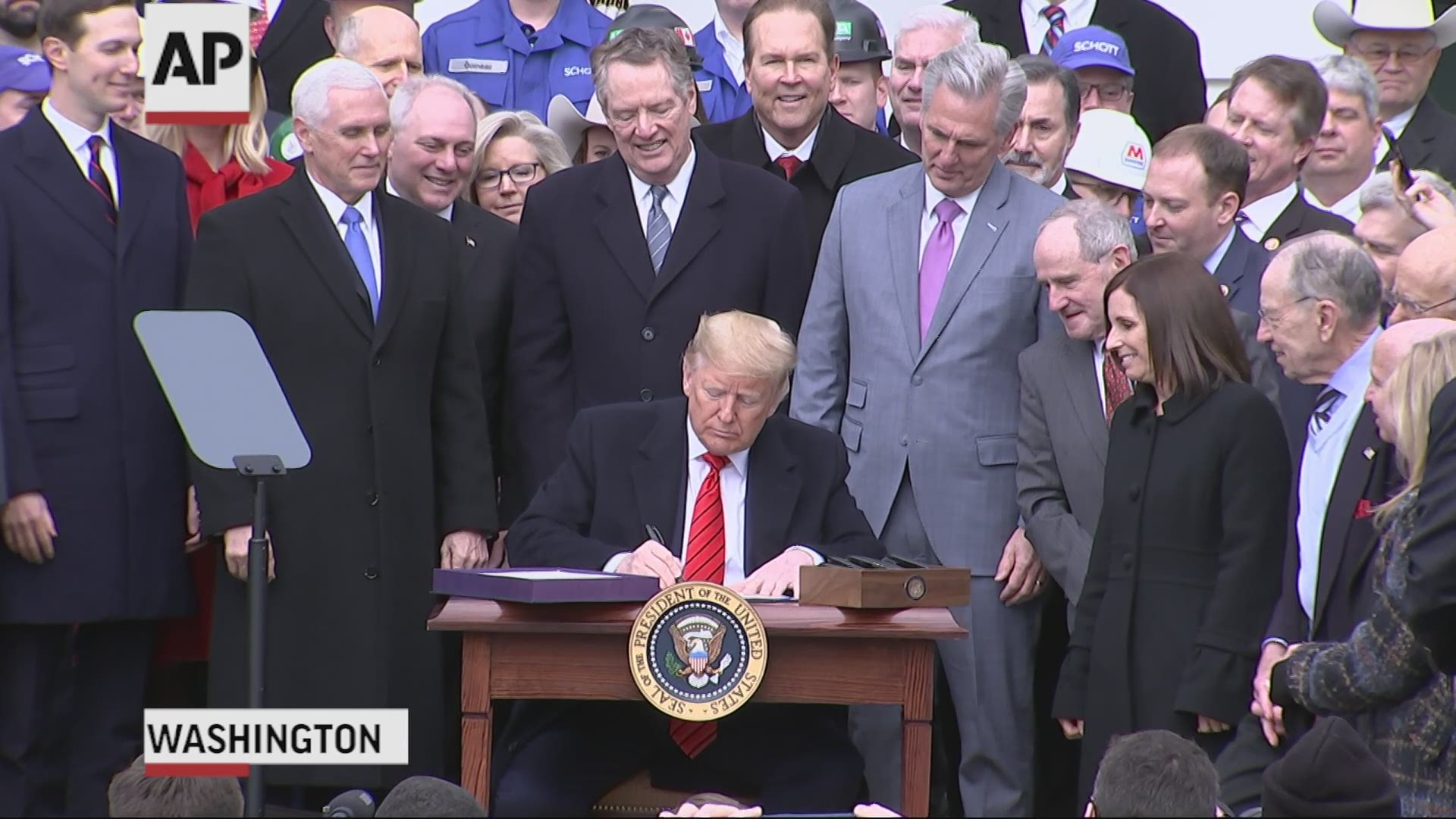 President Donald Trump has signed into law the USMCA trade deal, a major rewrite of the rules of trade with Canada and Mexico.