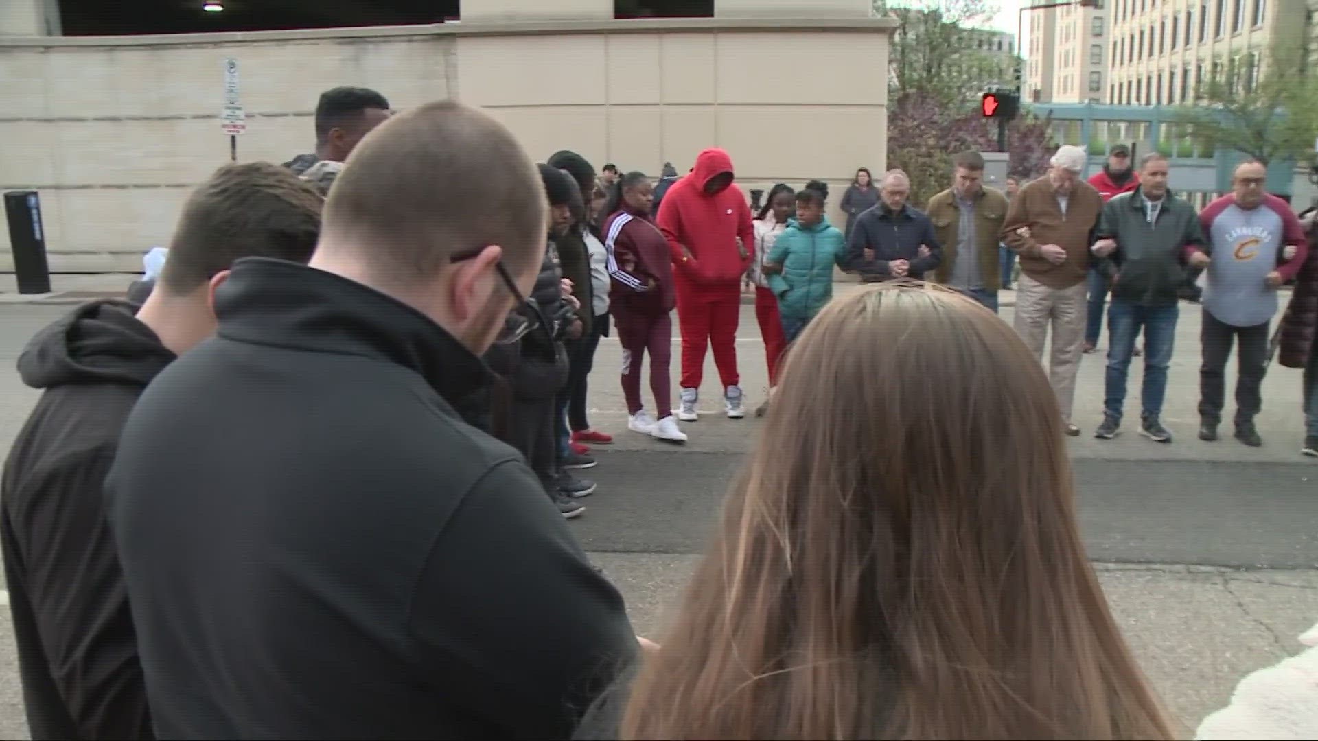 There was an eerie silence across the street from Akron's Justice Center on Tuesday evening, except that of prayer.