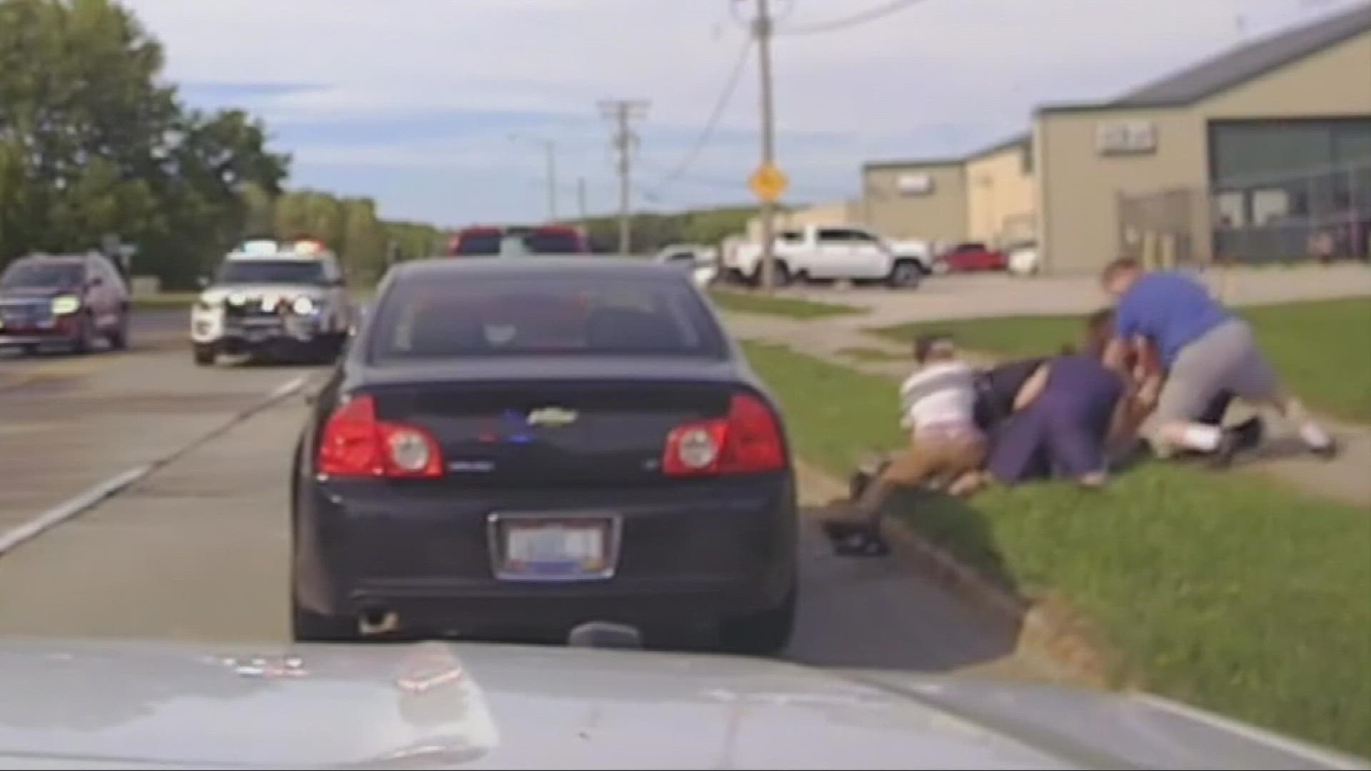 A man allegedly pushed the officer after being pulled over before a group of people stopped at the scene to assist.