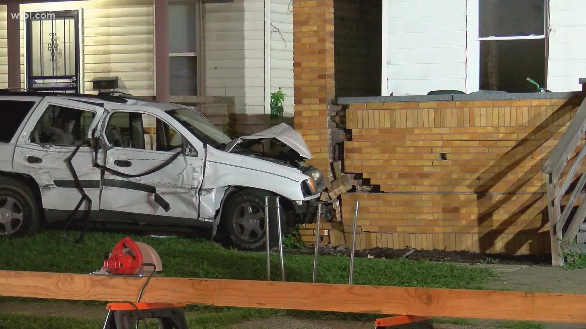 A white SUV slammed into a red Chevy truck before ricocheting into a house, the impact causing the porch to nearly buckle.