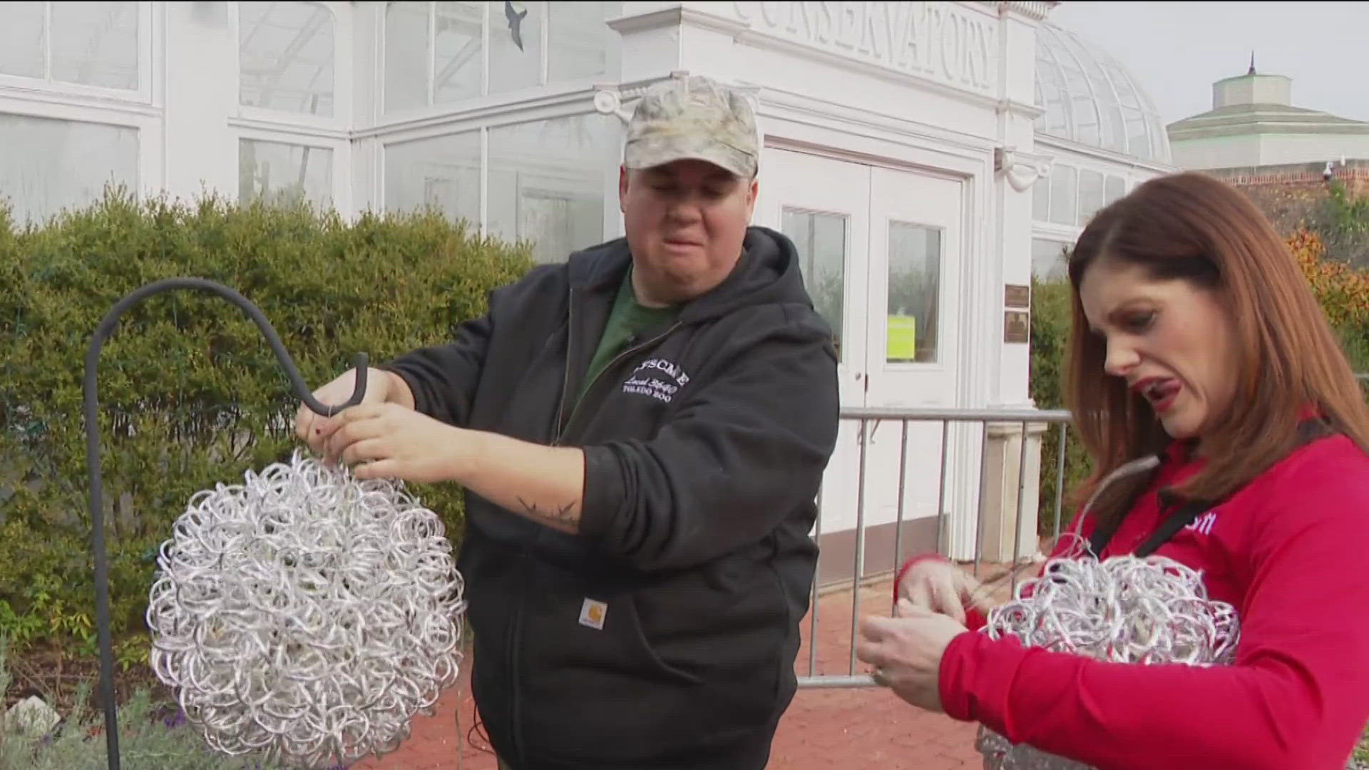 In a seasonal Try This! Amanda helps put some finishing touches on the festive decorations at the Toledo Zoo's Lights Before Christmas.