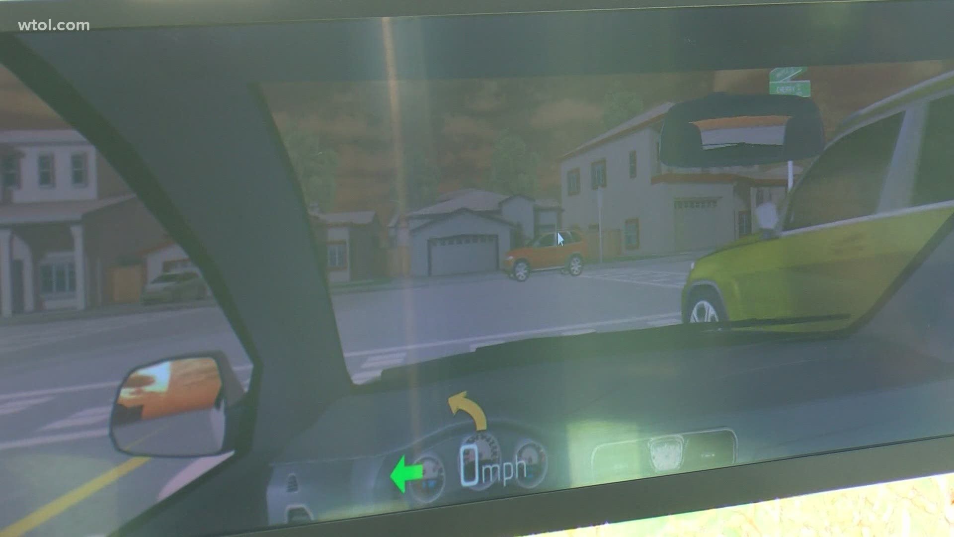 Driving simulator showing the dashboard, road, rear-view mirror