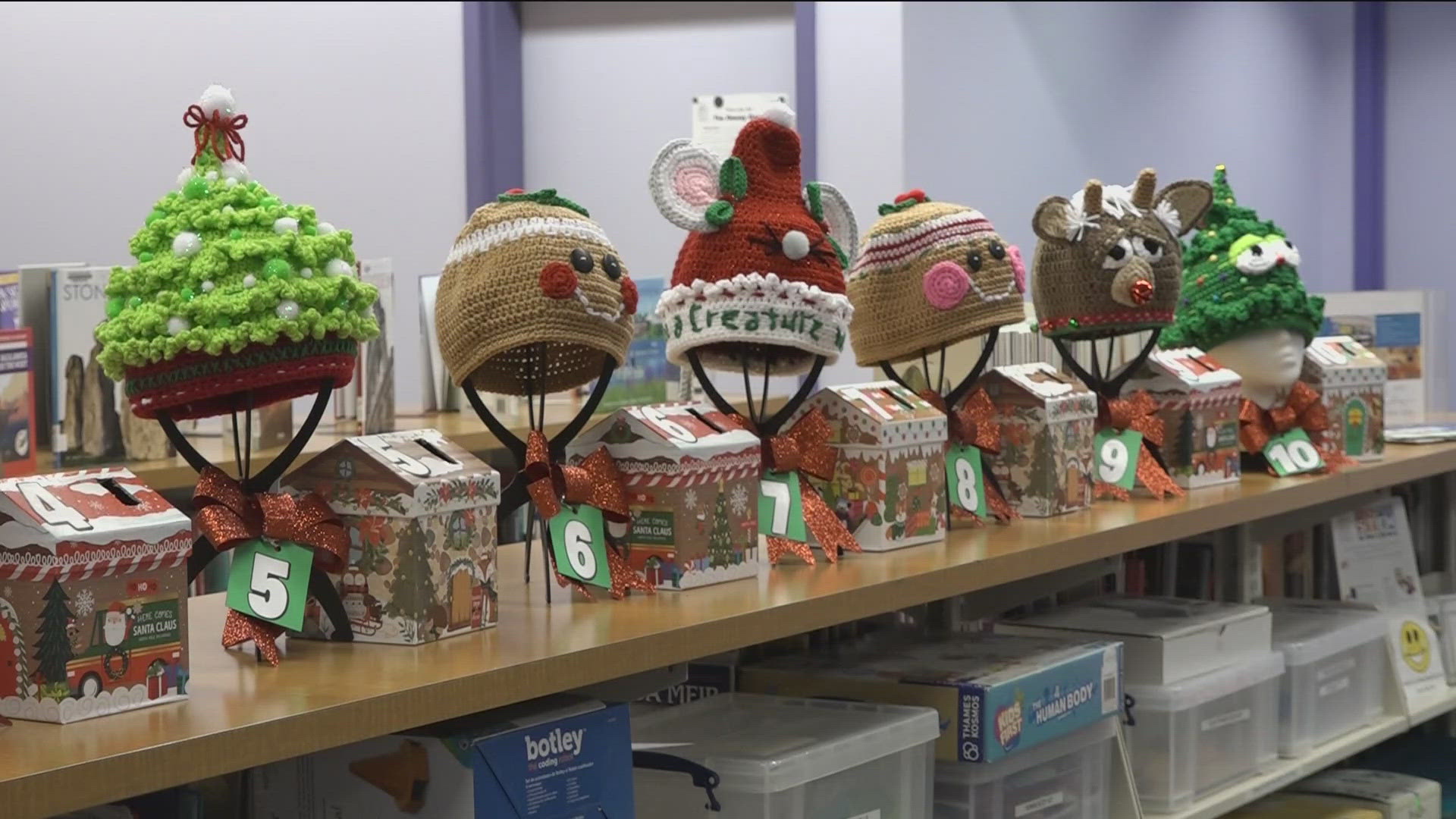 Denise Adams, an assistant librarian, is raffling off her homemade hats to raise money for the Ronald McDonald House Charities, a cause close to her heart.