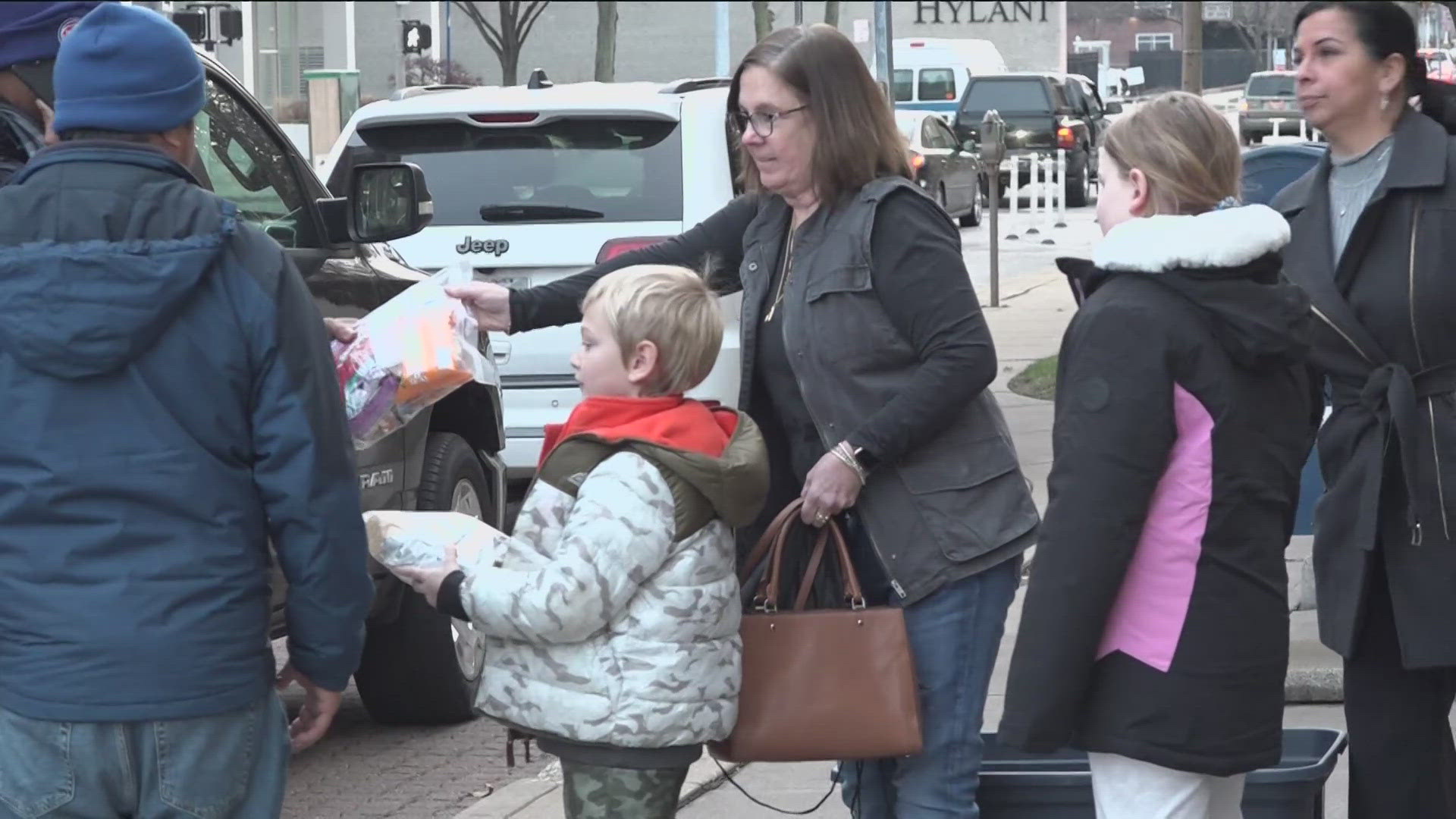 Beverly Elementary students and teachers gathered at the downtown Toledo library to pass out bags of useful items to those in need.