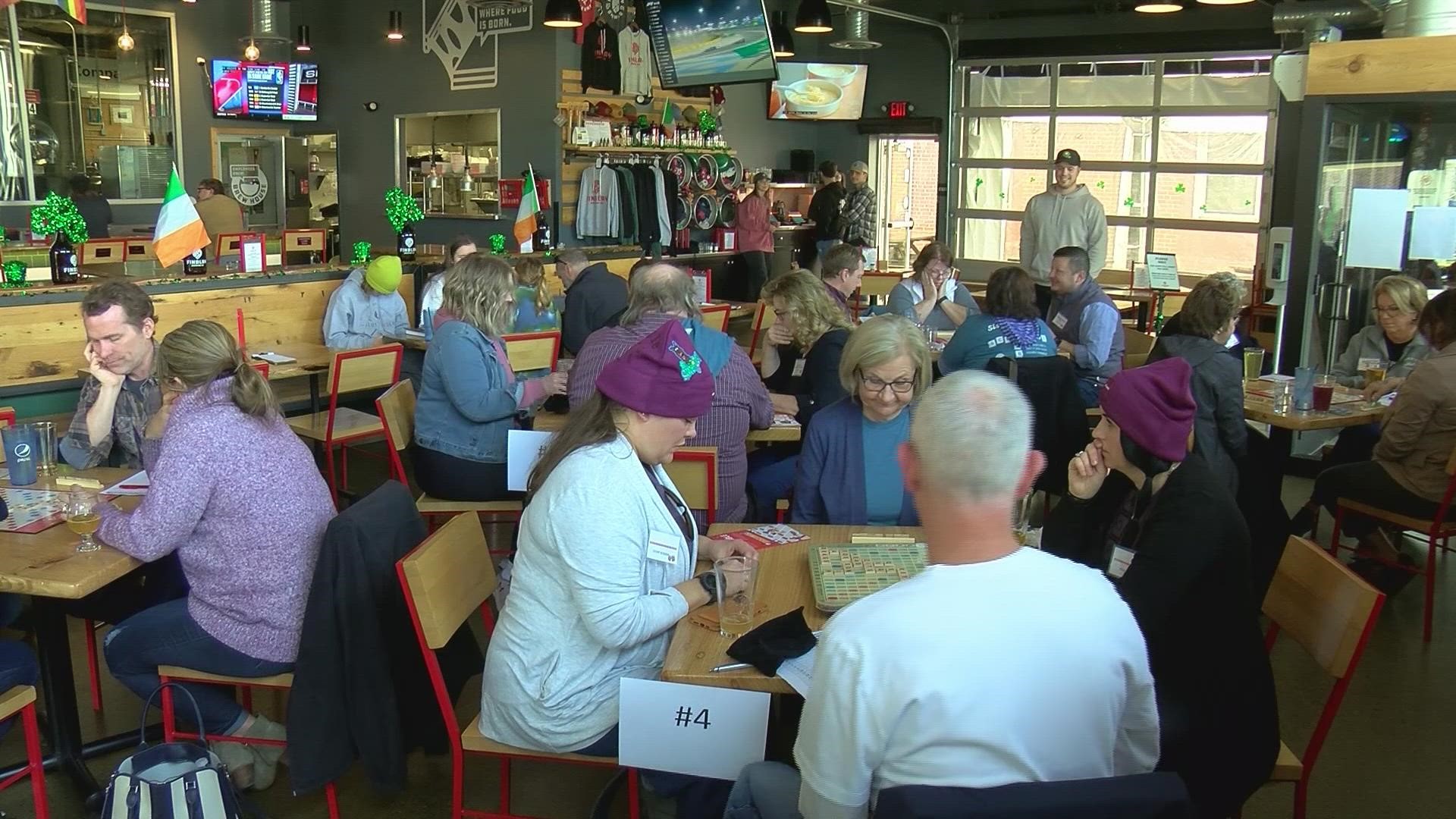 Dozens of Scrabble players got together at the Findlay Brewing Company on Sunday to drink beer and raise money for the Jerry Sisser Scholarship Fund.