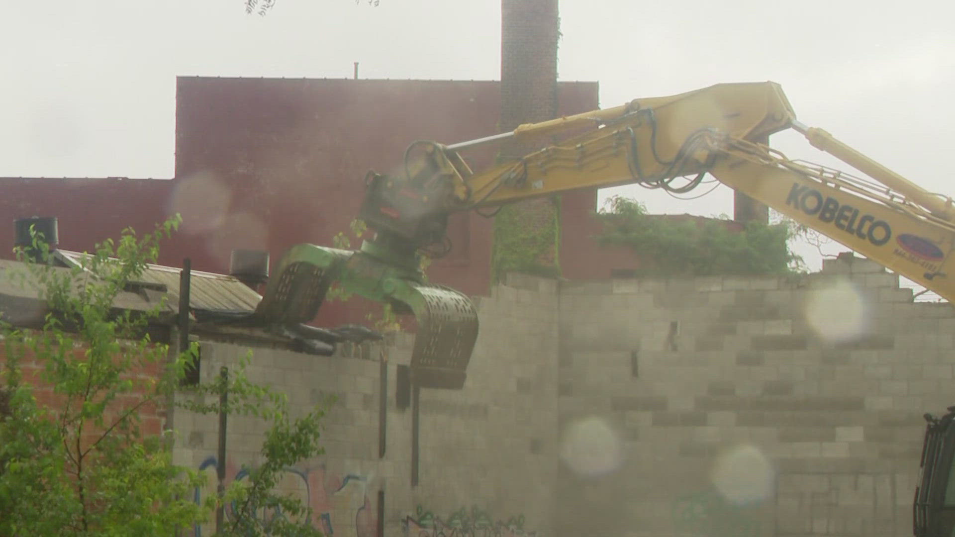 City and county leaders gathered Monday to demolish a crumbling commercial structure in the Warren Sherman neighborhood. 