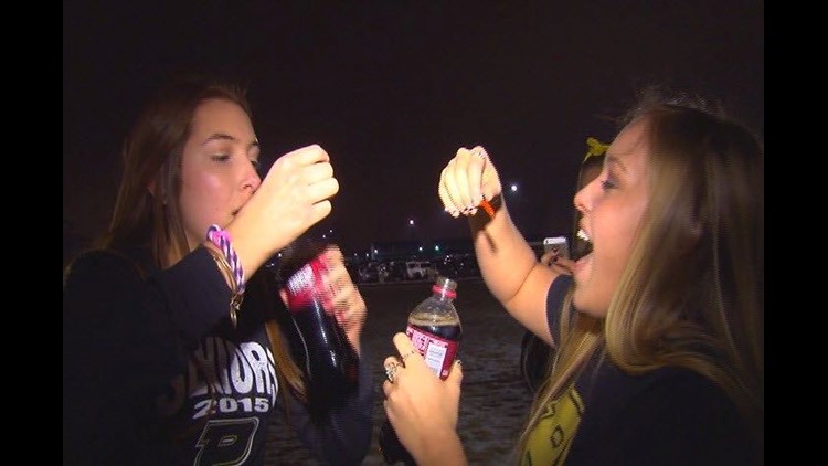 Perrysburg HS seniors swallowing goldfish for Maumee