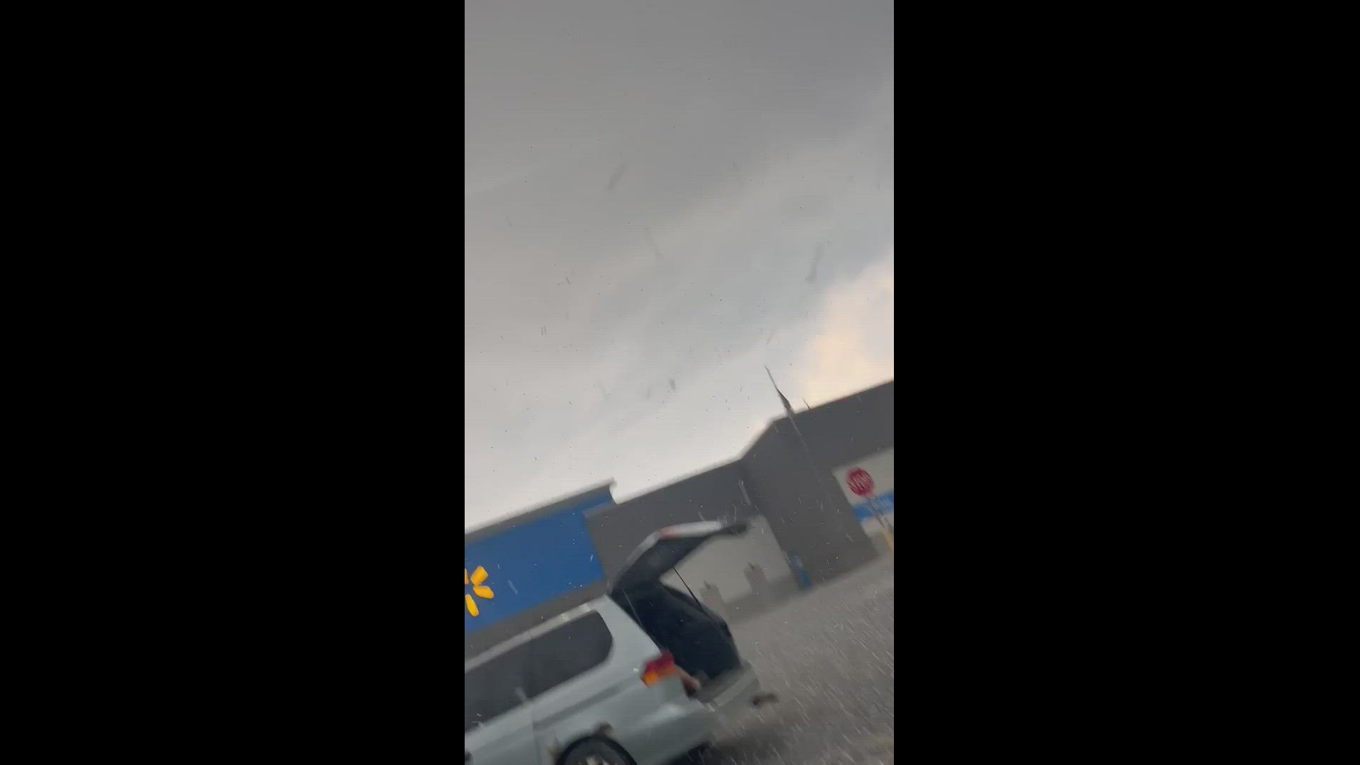 Video from Landon Demoss shows hail from Thursday's storm covering a Walmart parking lot.