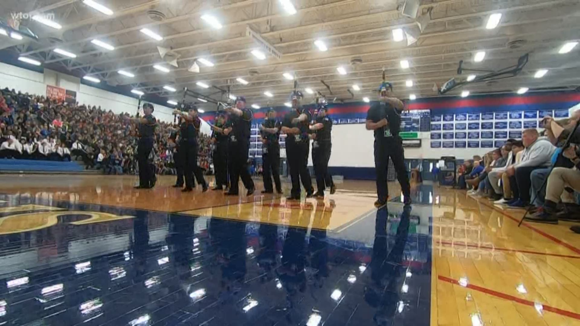 The annual assembly features a performance from the JROTC drill team.