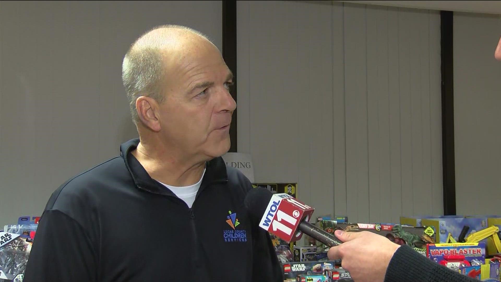 Kevin Milliken of Lucas County Children Services and WTOL 11's Michael Sandlin look over donated toys for foster children.