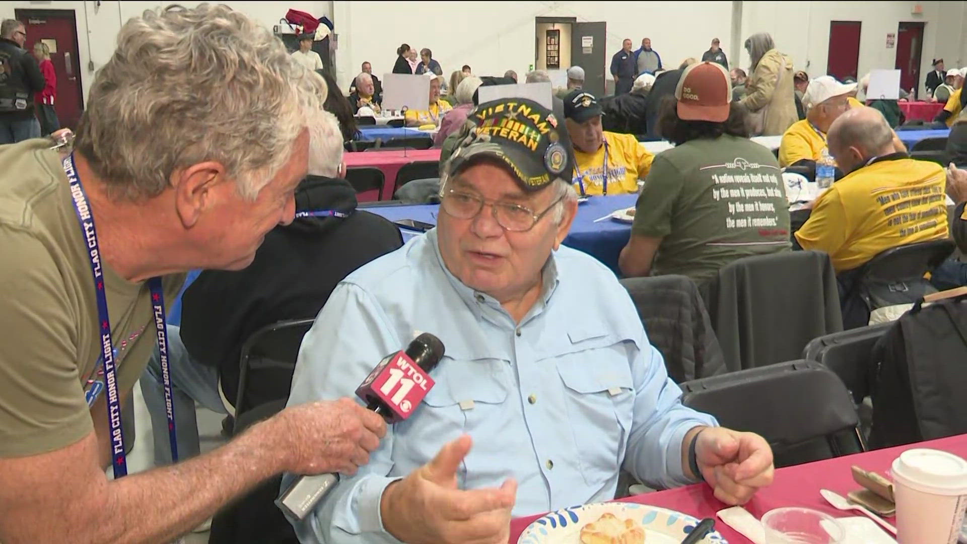 Dan Cummins chats with a Vietnam War Veteran ahead of a Flag City Honor Flight to Washington, D.C.