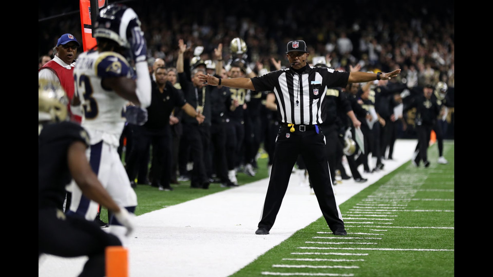 Why do referees wear black and white stripes?