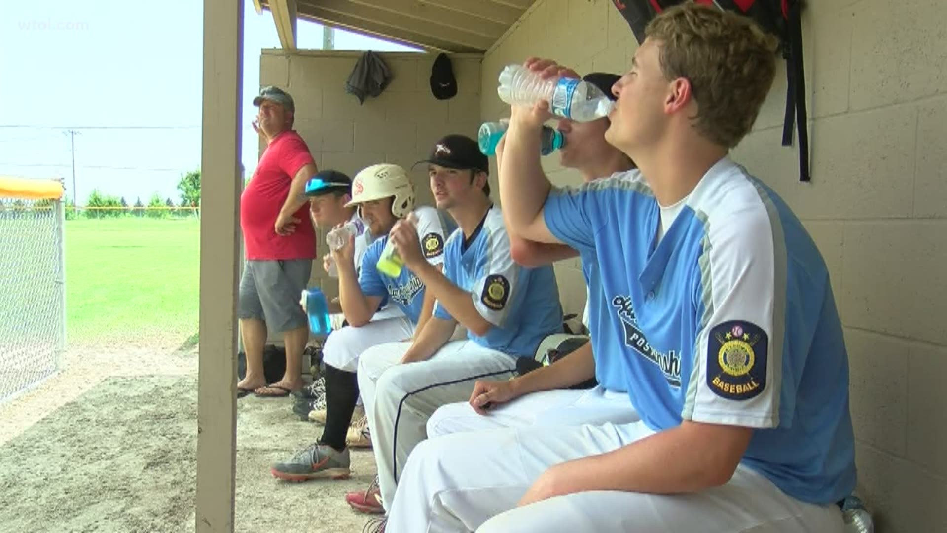 The boys out in the field in Pemberville took precautions against the heat.