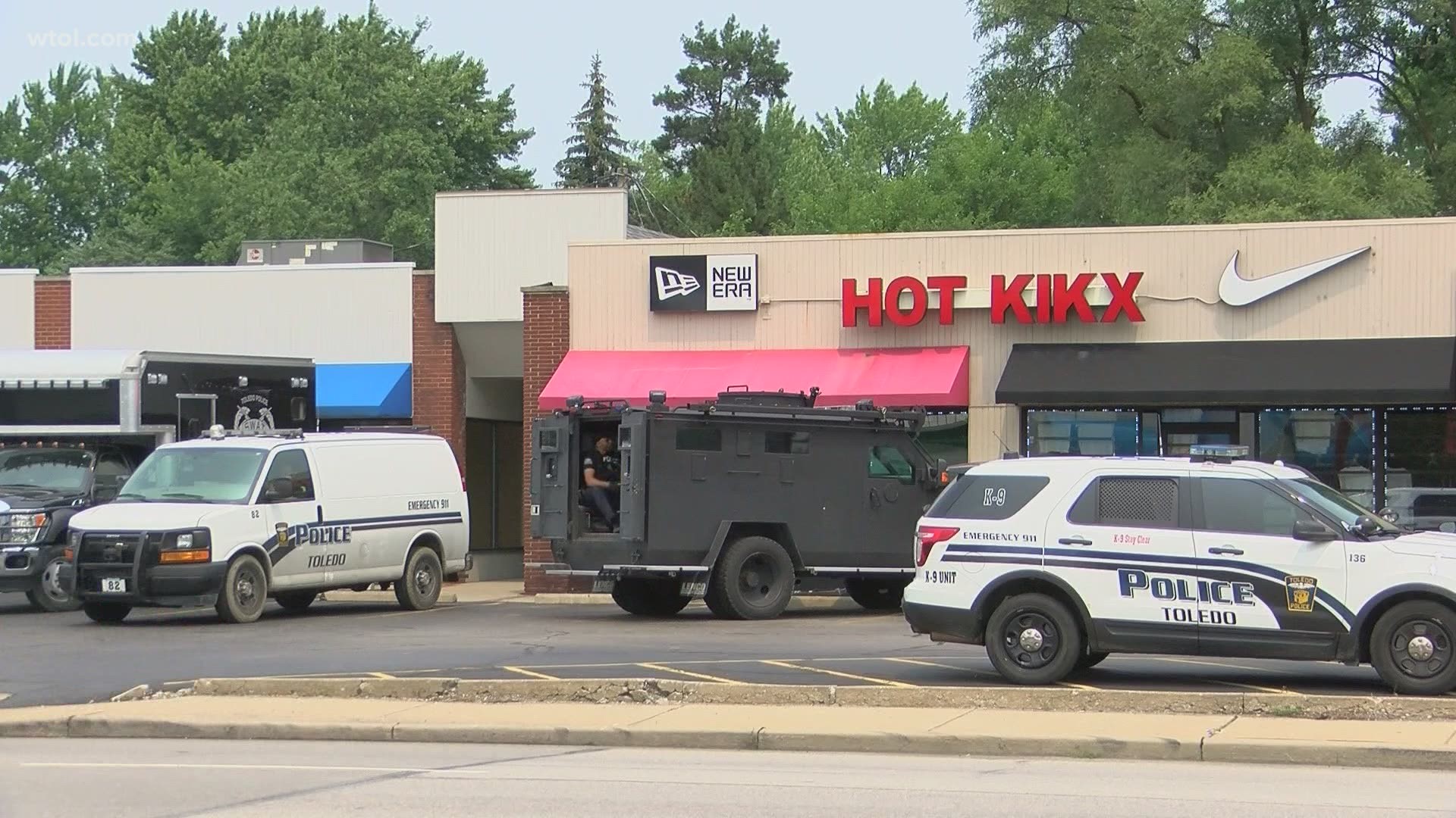 Officers were seen at the plaza on Monroe Street and Secor Road, across from a Kroger store, just after 12:30 p.m.