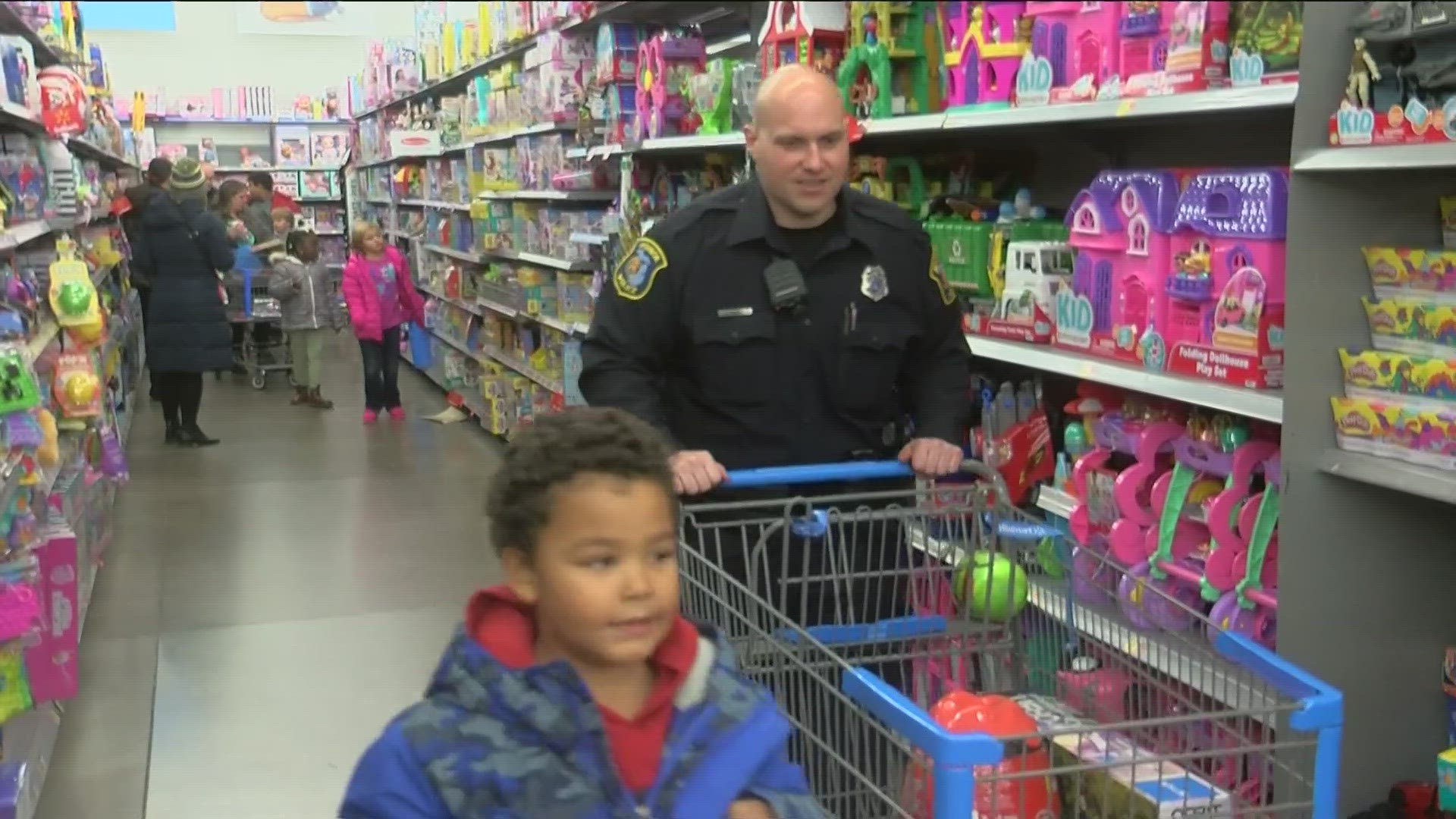 Monroe police officers put aside fighting crime to fight the holiday shopping crowds instead, grabbing carts and partnering with children for 'Shop With a Cop.'