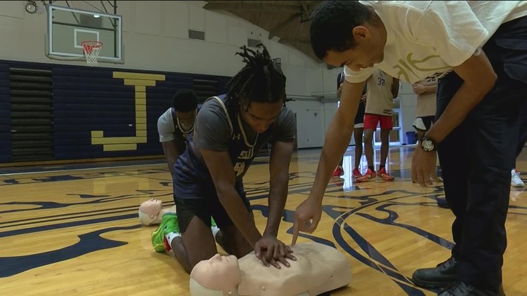 Toledo firefighter Myles Copeland teaches CPR at St. John's