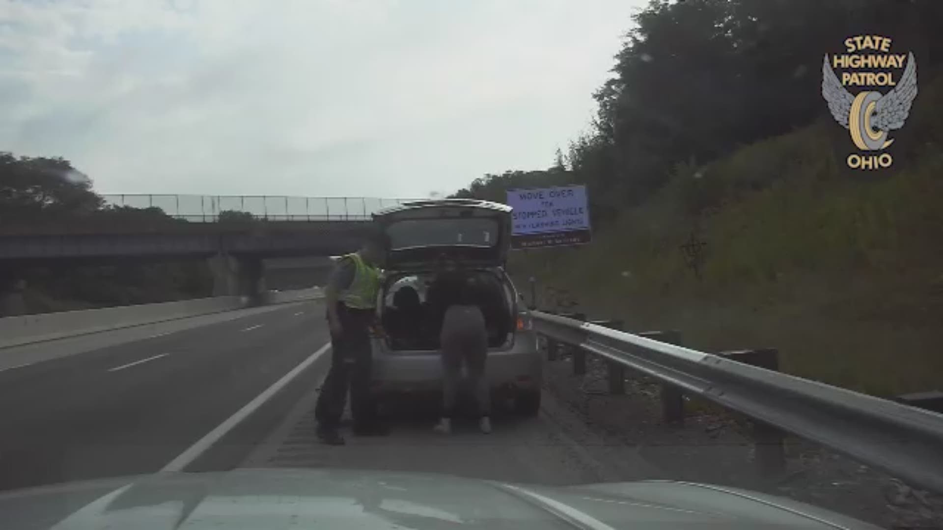 Video shows a trooper working to replace a tire on a disabled vehicle last weekend when a U-haul truck veers off the road, striking the cruiser.