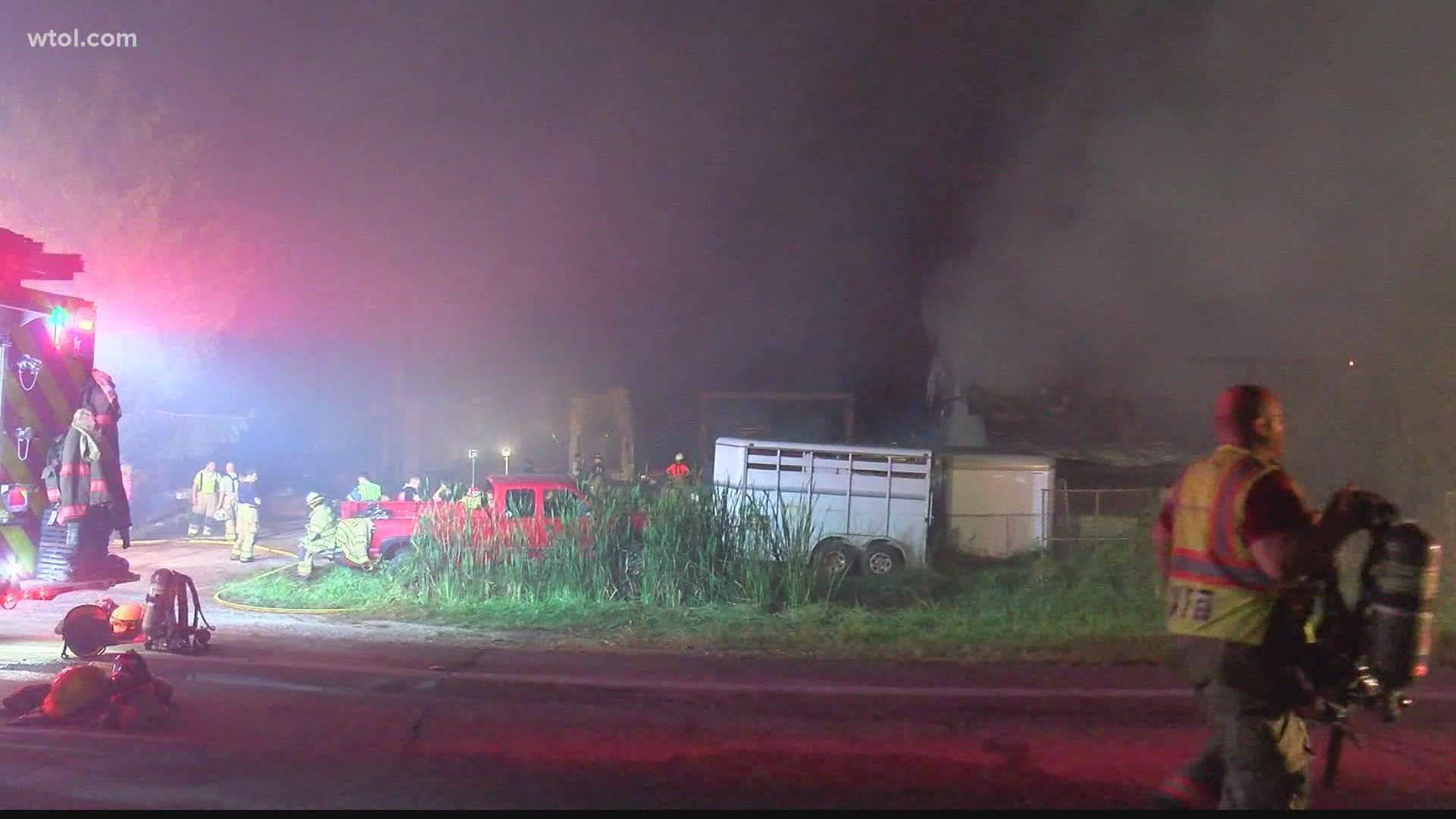 Officials say they saw cows and pigs running down the road and the barn fully engulfed in flames when they arrived at the scene of Artz's Feed & Supply.
