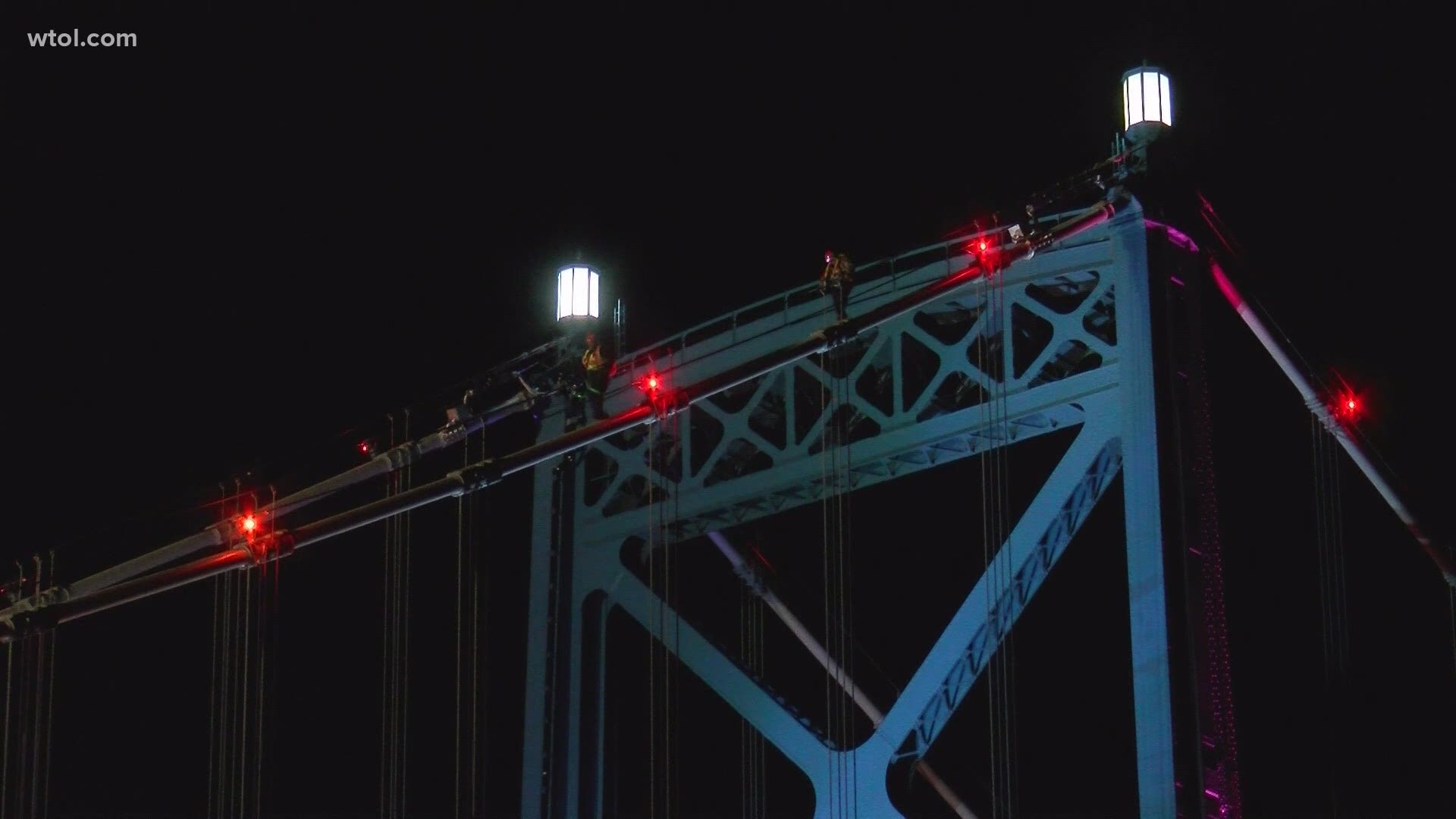 The woman made it all the way to the top lanterns. According to bridge data from ODOT, the towers of the Anthony Wayne Bridge are 215 feet tall.