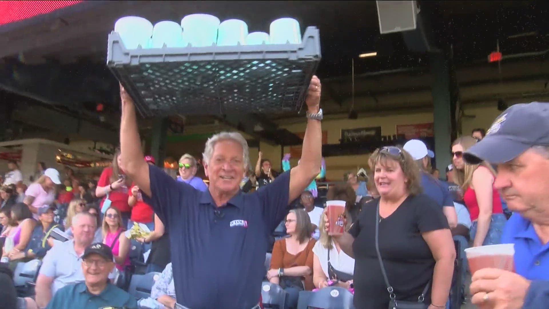 WTOL 11's Dan Cummins tries his hand at crafting cotton candy, selling the sweet treats to the crowd and bartering for beer at a Toledo Mud Hens game.