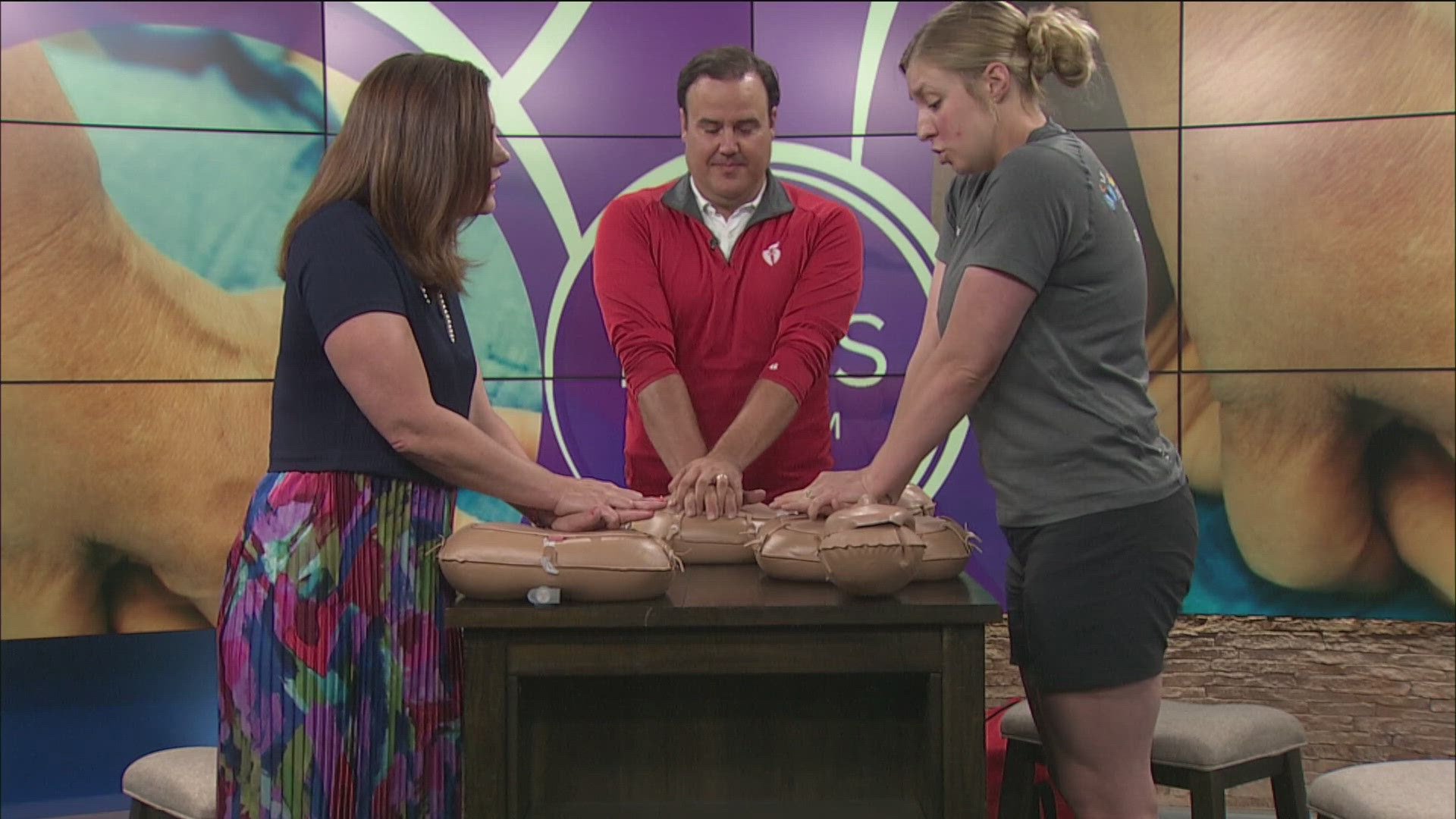 Tim Lewis with the American Heart Association and Jordyn Blood Rath with Nationwide Children's Hospital - Toledo demonstrate CPR and talk the importance of AEDs.