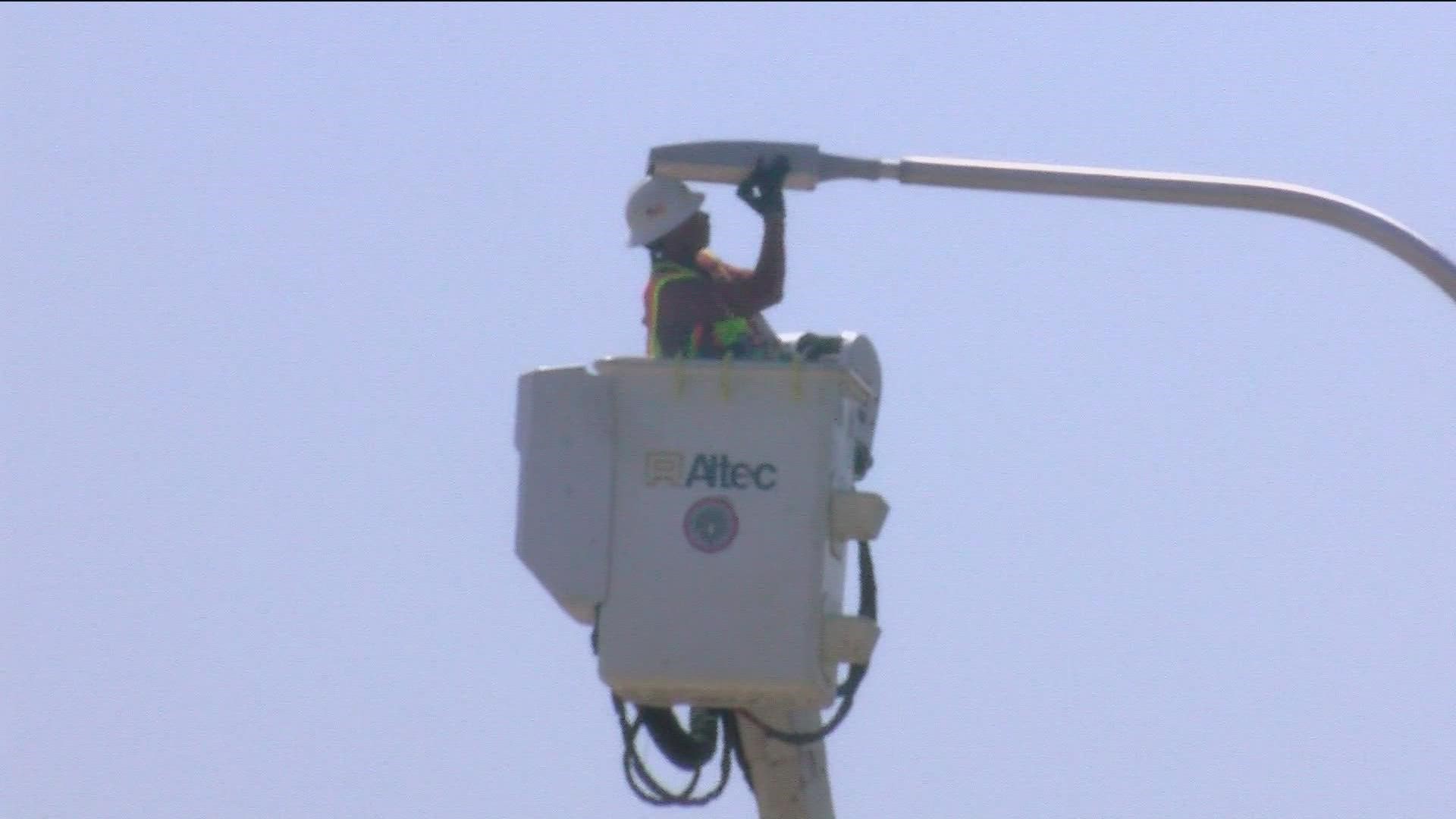 ODOT workers are covered in gear from head to toe: wearing jeans, boots, vests and hard hats, making a hot day feel even hotter.