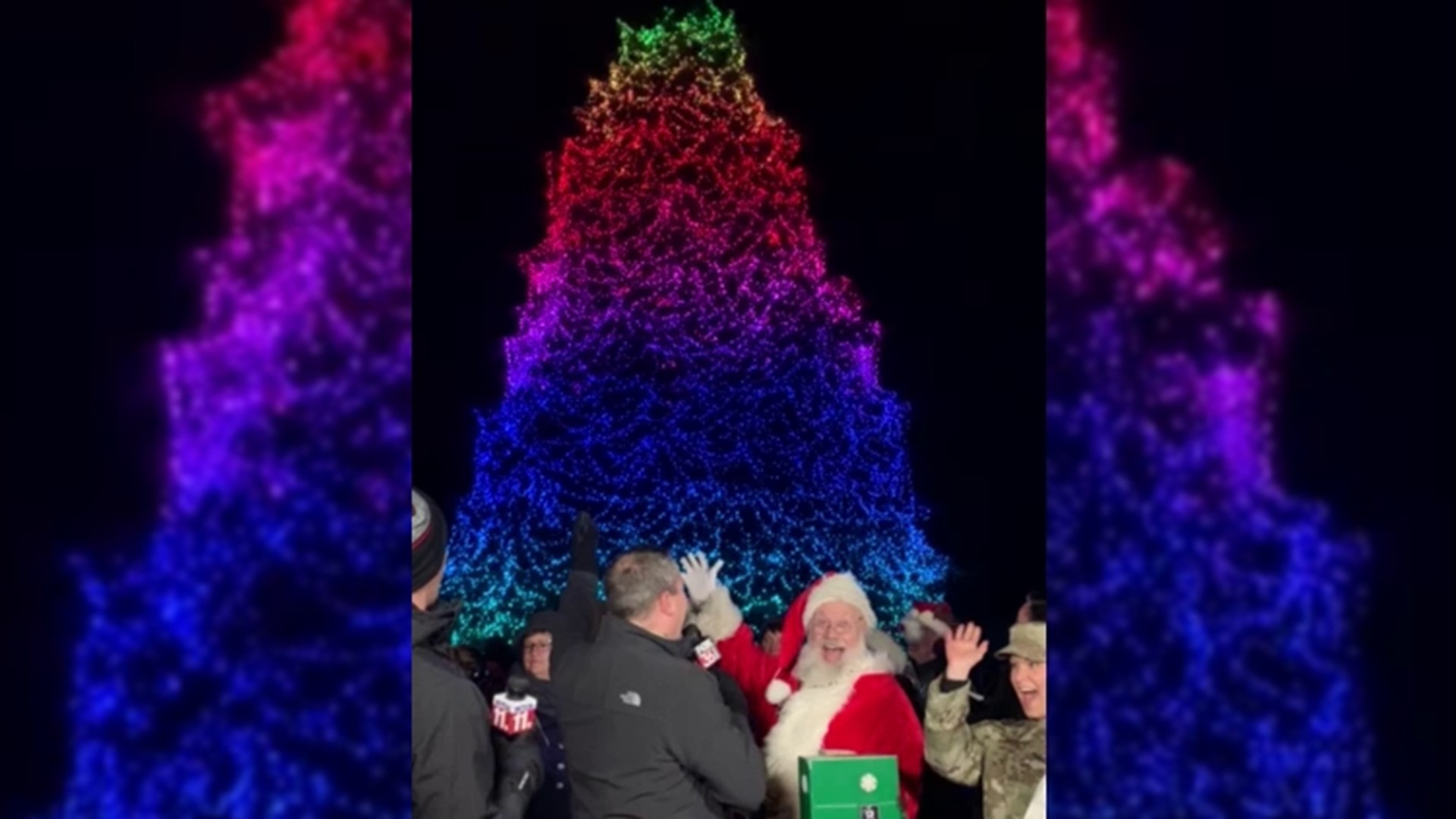 Master Sgt. Ariel McVicker and her son, 3-month-old George, flip the switch and light the Norway spruce at Toledo Zoo's Lights Before Christmas for 2021!