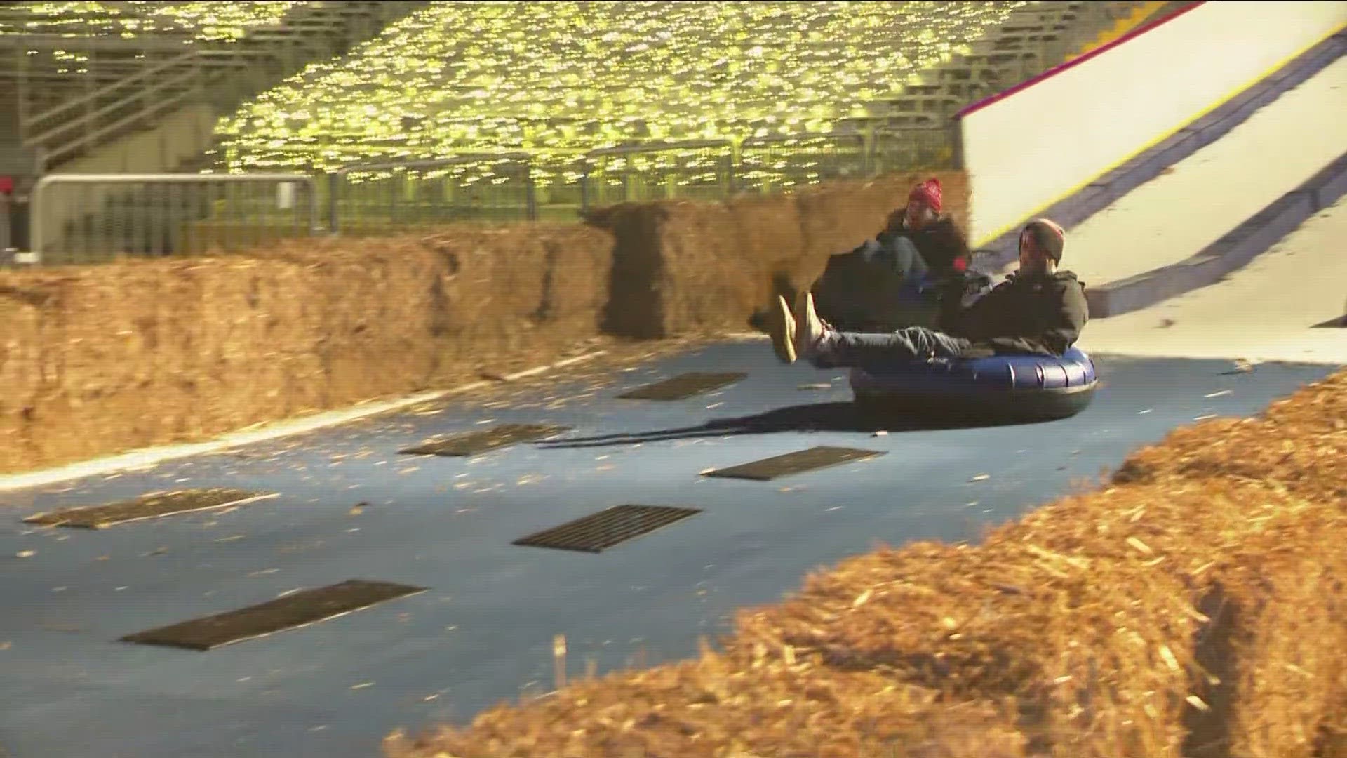 WTOL 11's Jon Monk and Kaylee Bowers take on the ice slide at the Winter Village as part of Toledo Zoo Lights Before Christmas.