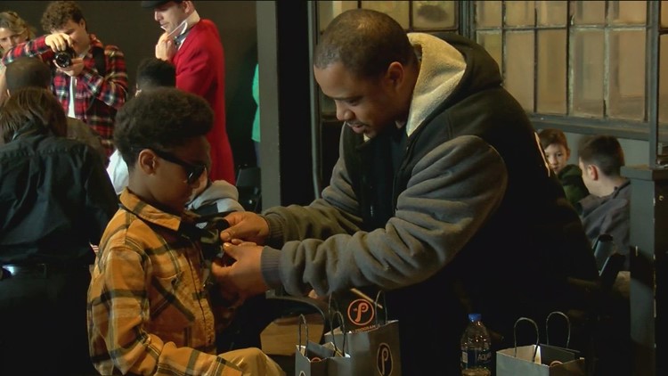 Kids learn how to tie a tie and other professional skills at mentorship event