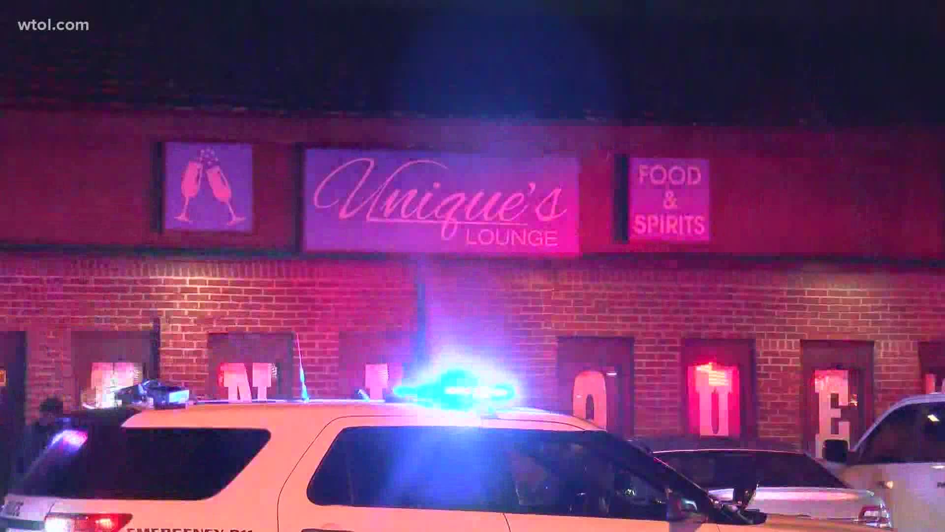 Detectives say a gunman shot into the bar and the woman was hurt as a bullet shattered the glass.