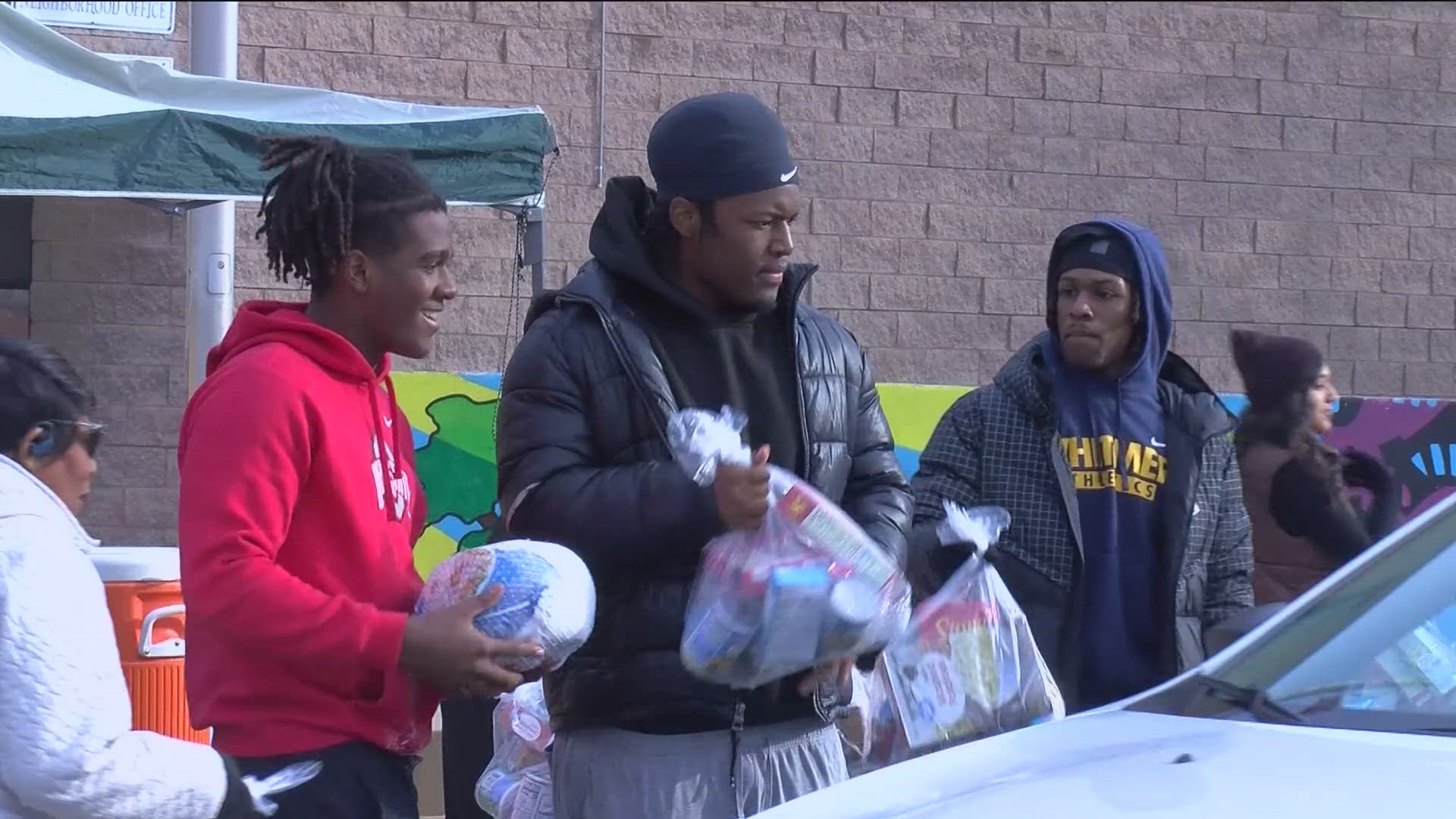 Seniors Isaiah Holmes and Carter Lowe handed out over 150 turkeys and other nonperishable items to those in need in central Toledo on Sunday.