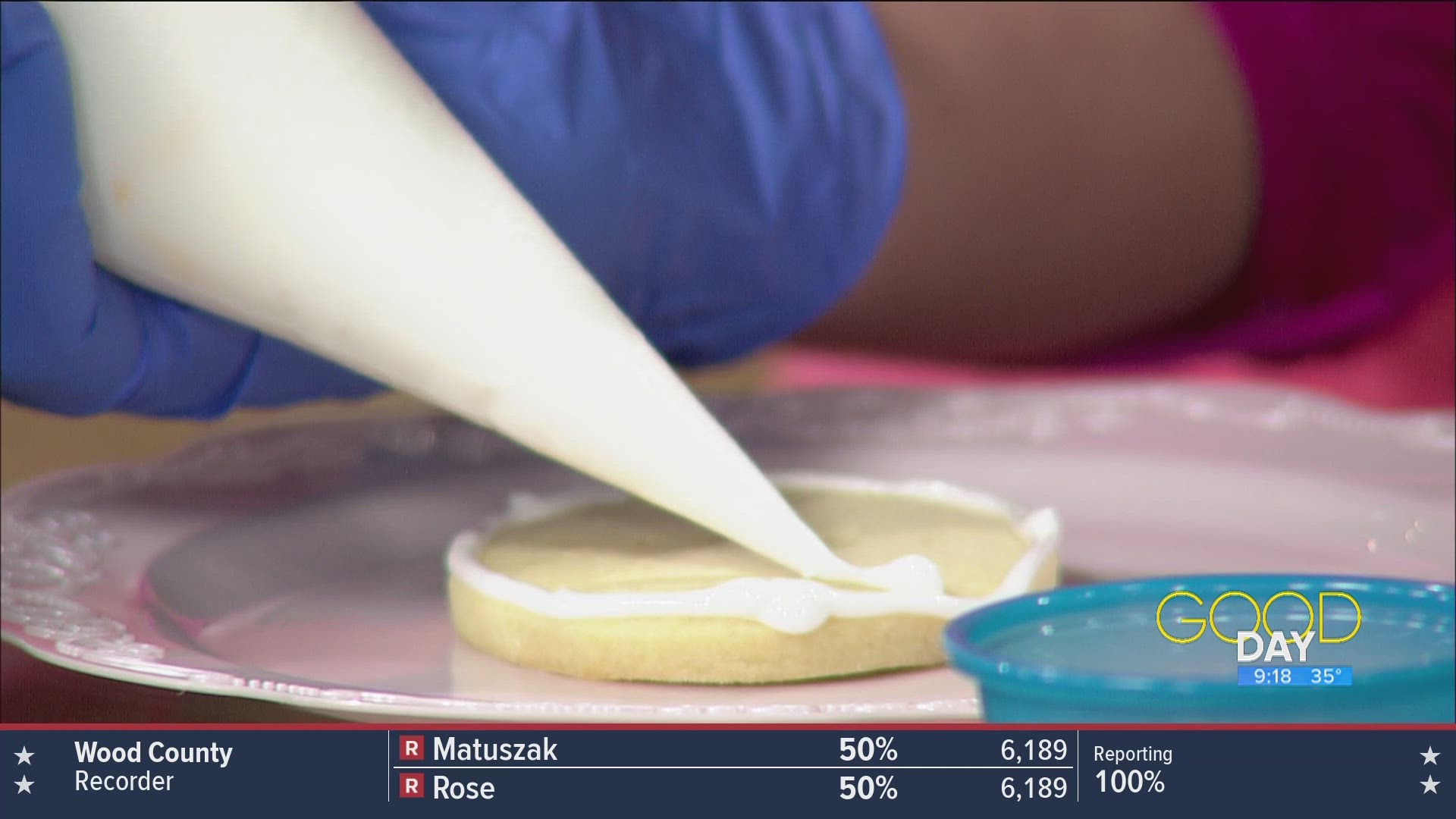 Jessica McKiddy of McKiddy Cakes decorates some Easter cookies with Amanda and Kaylee.