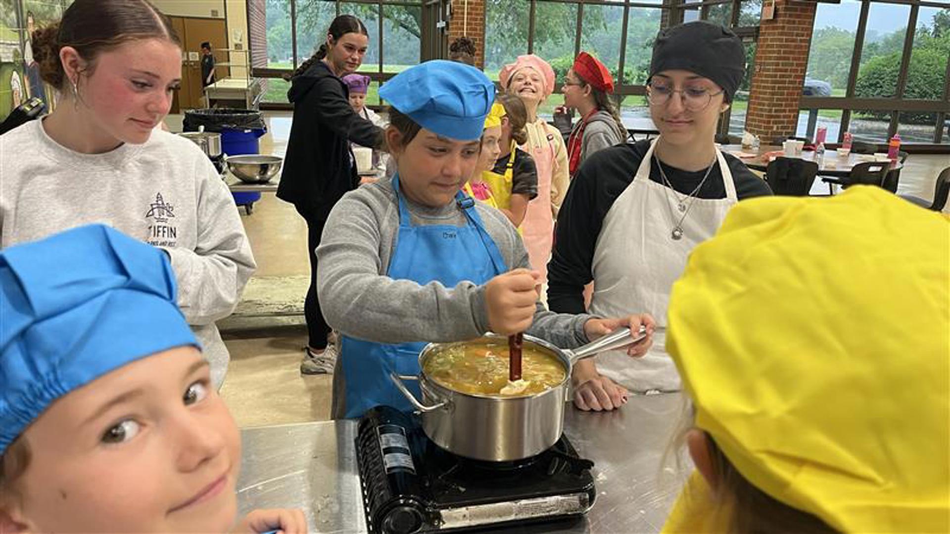 Dozens of 8 to 12-year-olds learn culinary skills from culinary students at the Vanguard Sentinel Career & Technology Centers.