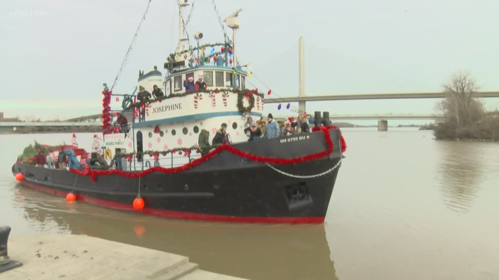 Great Lakes Museum creates a new tradition on Maumee  River and delivers Christmas trees by boat to those in need in east Toledo.