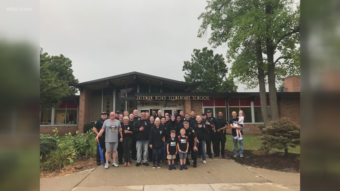Dozens of TPD officers walk Officer Dia's sons to school