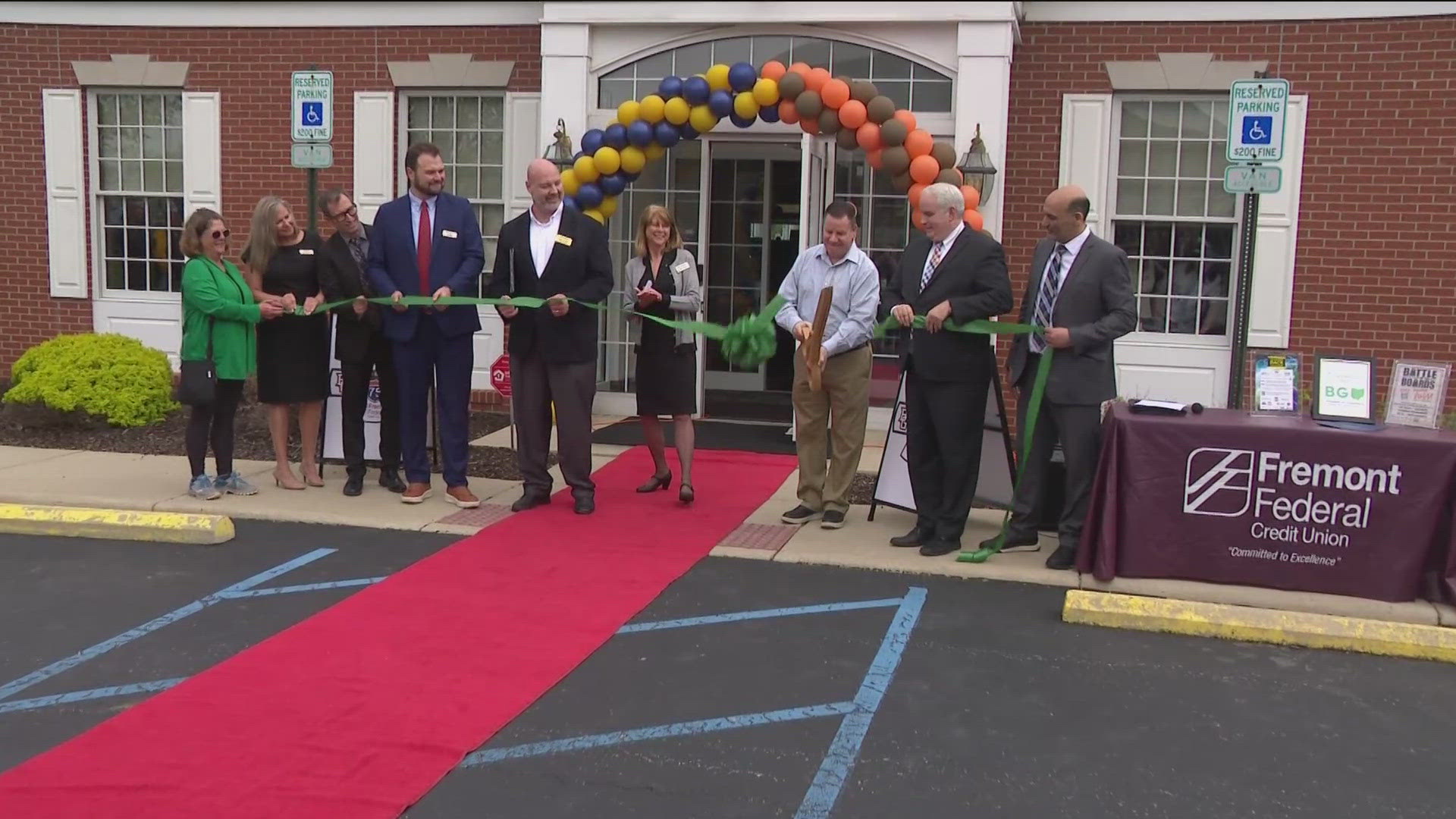 Eddie George from BGSU and Jason Candle from the University of Toledo were at the ribbon-cutting to celebrate the bank being a Battle of I-75 sponsor.