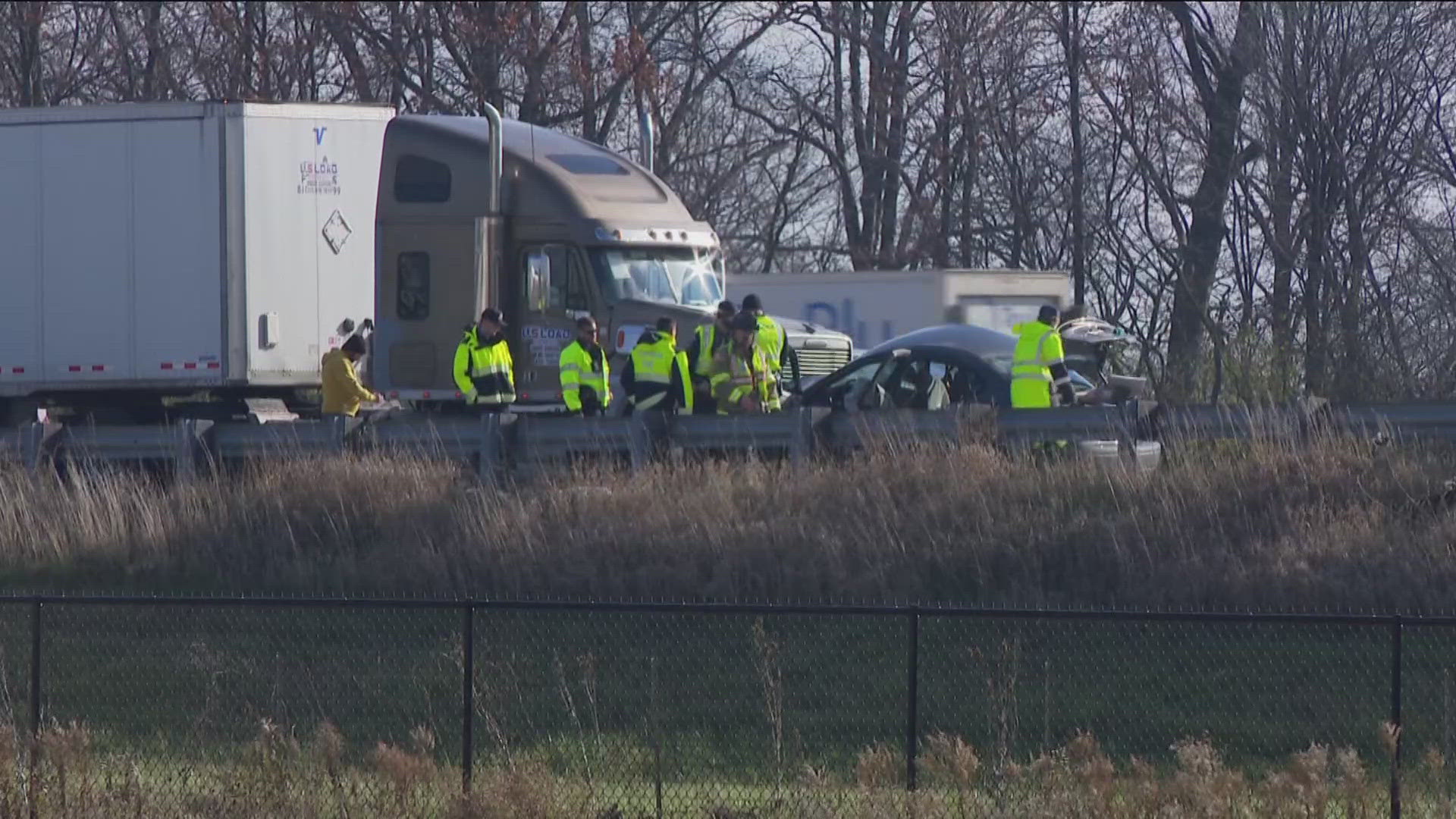 Preliminary reports are that the car crossed the center median from the southbound side and hit the semi. At least one person was taken to the hospital.