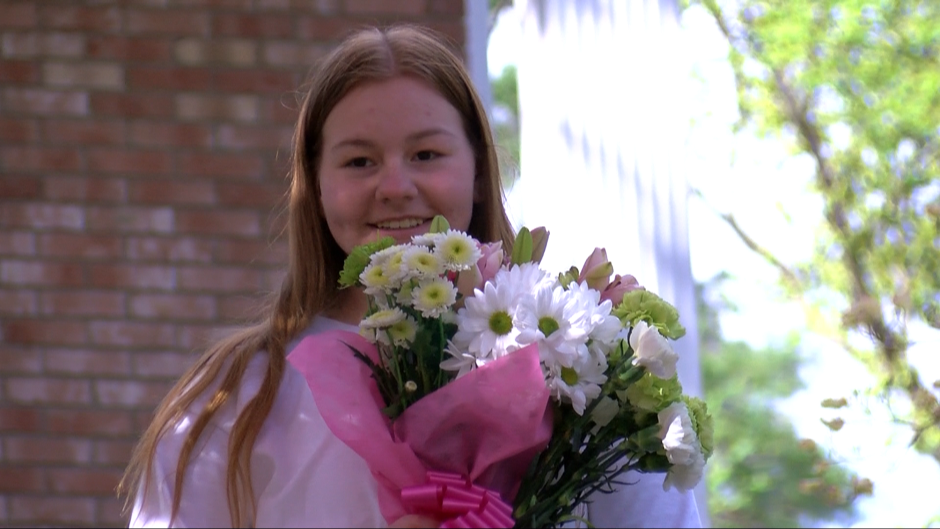 The team dropped off flowers and presents, honoring her four years as a Green Bear.