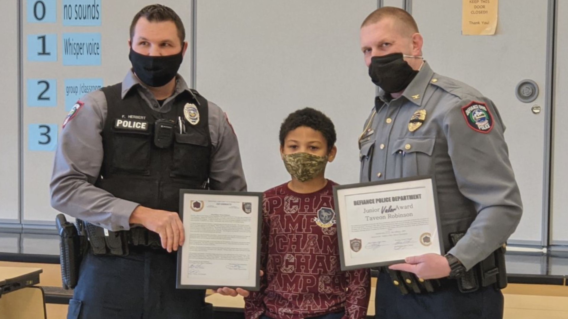 Taveon Robinson was rewarded by Defiance police with a "Junior Valor Award" certificate Wednesday afternoon.