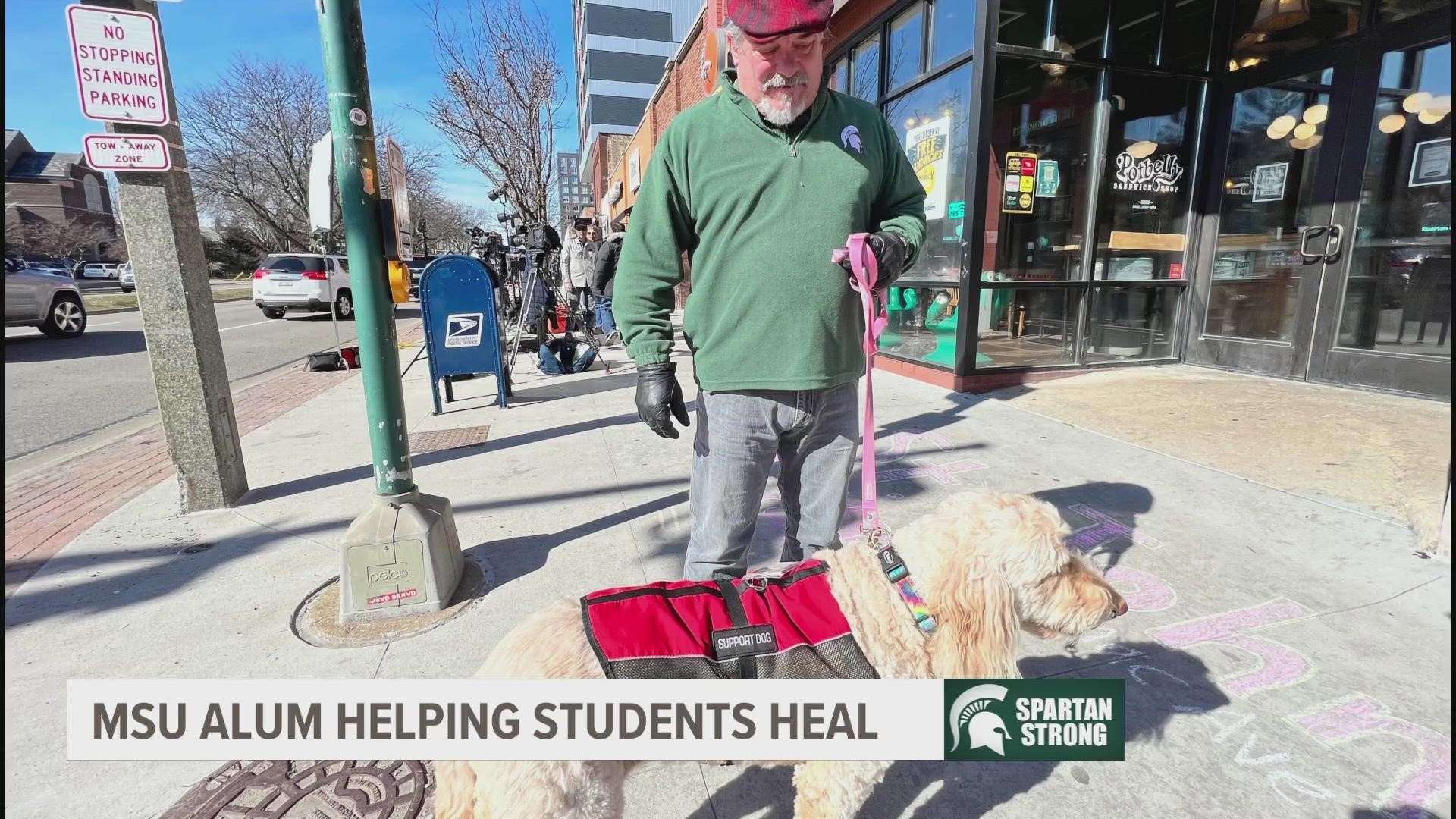 Right outside the building where the shooting started is one Michigan State alum and his dog, Pearl, hoping to bring a little bit of comfort.