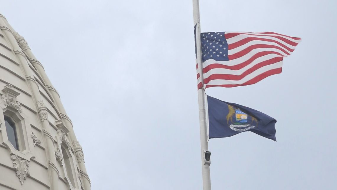 Why are the flags lowered to half-staff in Michigan?